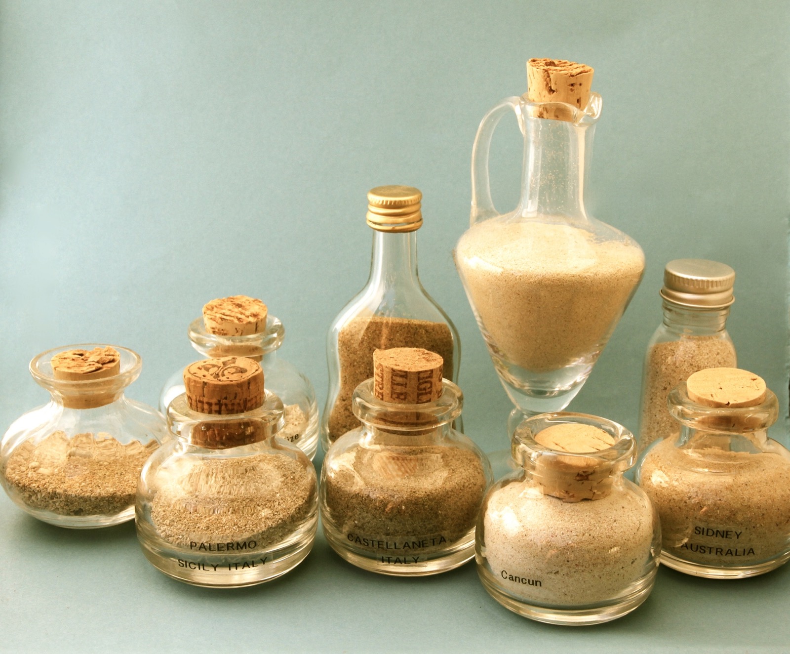 Jars of sand collected from beaches, one labelled Castellaneta, Italy